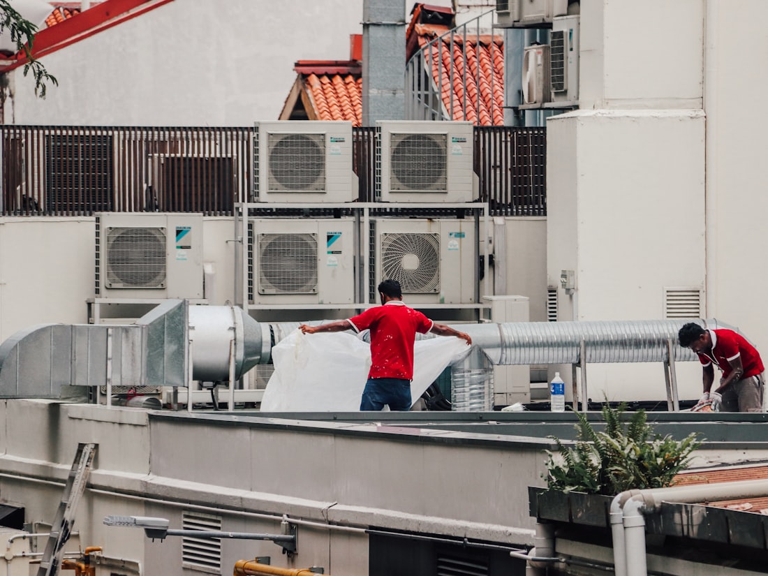 HVAC technicians on a rooftop while AI handles incoming calls